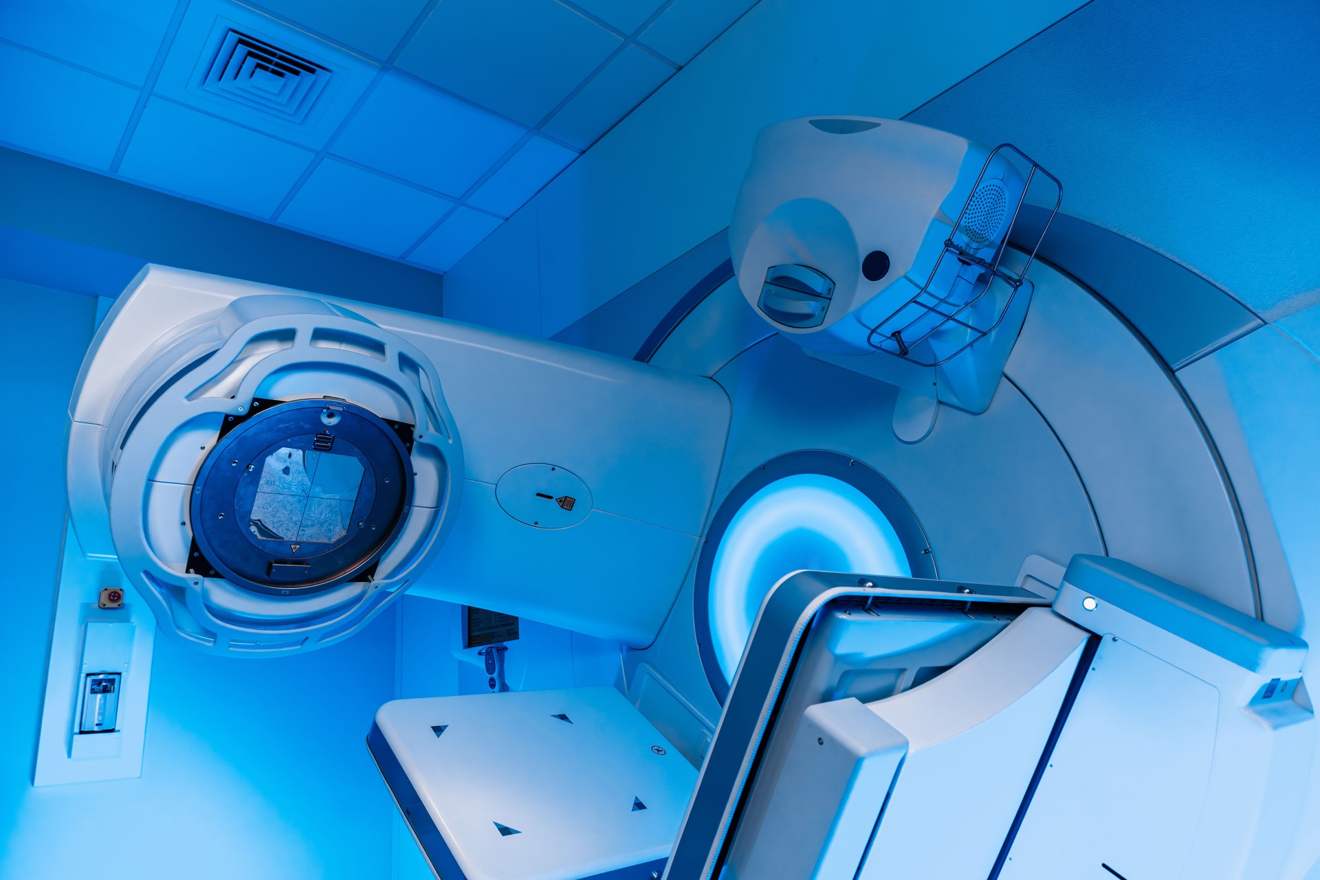 A radiation therapy machine is located in a state-of-the-art medical facility, ready for use in cancer treatment.